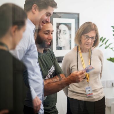 The Crane design team looking at a house note with Professor Jane Raymond